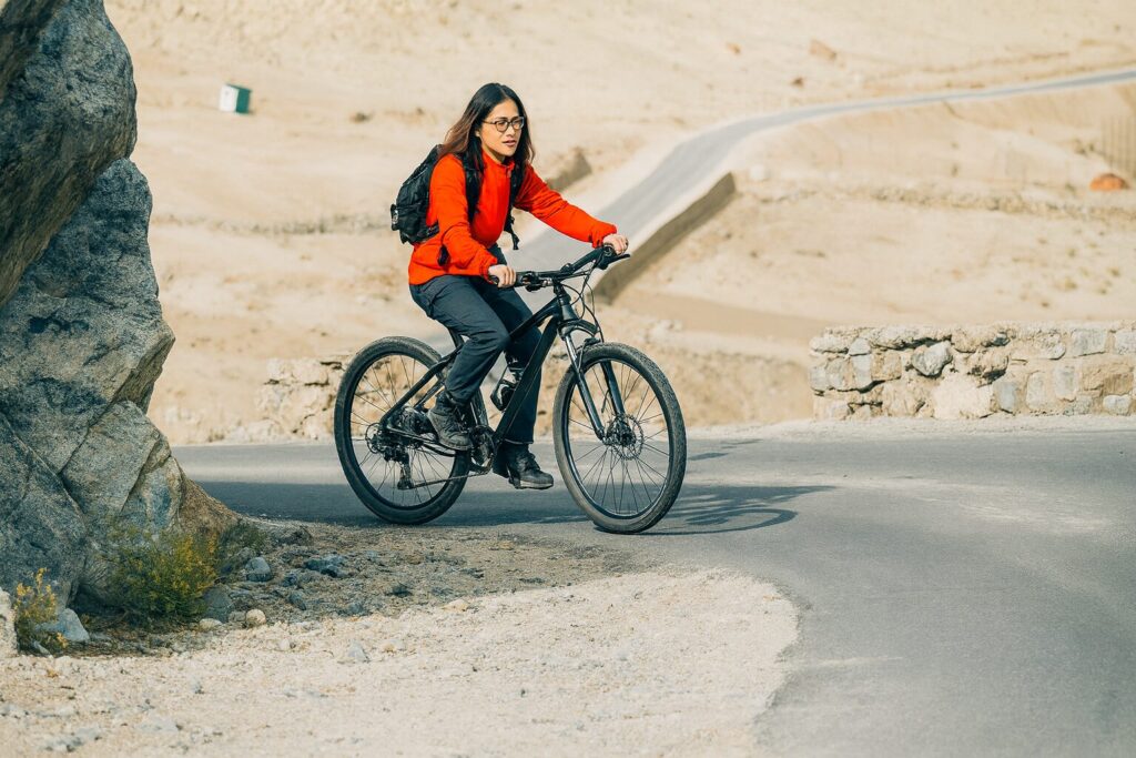 girl riding bicycle in mountains