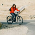 girl riding bicycle in mountains